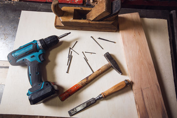 Drill,hammer and steel spike on the table