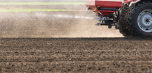 Tractor Spreading Artificial Fertilizers In Field