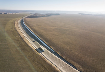 Wall Mural - Aerial Top View of Truck with Cargo Semi Trailer Moving on Road in Direction