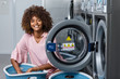 © Samuel B. - Young black African American woman washing her clothes in a automatic laundry