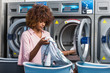 © Samuel B. - Young black African American woman washing her clothes in a automatic laundry