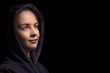 © Валерий Моисеев - Portrait pensive artist painter girl in black hood posing in a studio. Creative painter girl, isolated on black