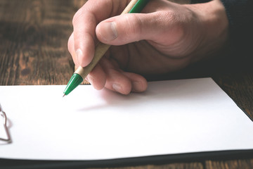 Wall Mural - Businessman is signing a blank document on office table by a pen in his hand.