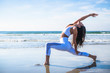 © Cavan Images - Woman doing yoga on beach