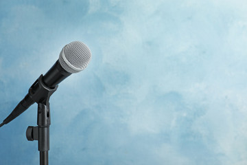 Wall Mural - Modern microphone on color background. Space for text