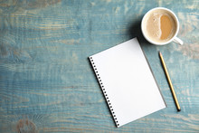 Notebook And Coffee On Wooden Background, Top View With Space For Text