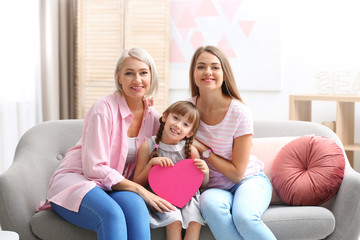 Poster - Beautiful mature lady, daughter and grandchild with gift box at home. Happy Women's Day