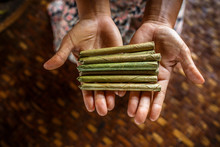Hands Of Woman Holding Pile Of Cheroot Cigars