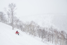 Telemark skiing in powder near Niseko United resorts in Hokkaido.