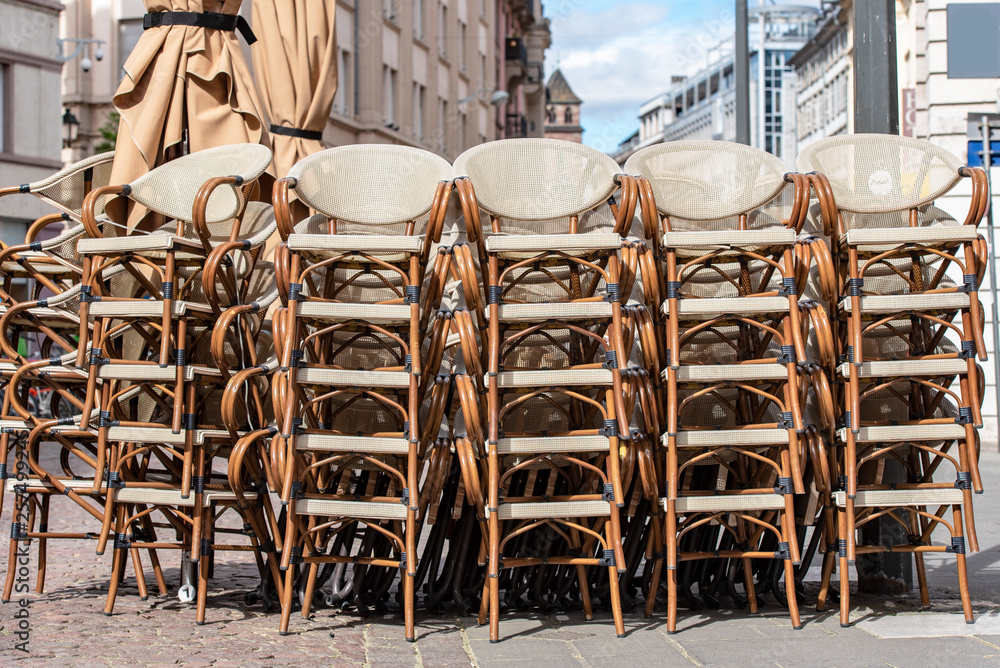 Rows of traditional Chairs of a Street Cafe in France, french furniture in a Street  - obrazy, fototapety, plakaty 