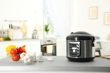 Poster - Modern multi cooker and products on table in kitchen