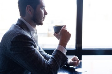 Canvas Print - Business man drinking coffee in a cafe - coffee time.