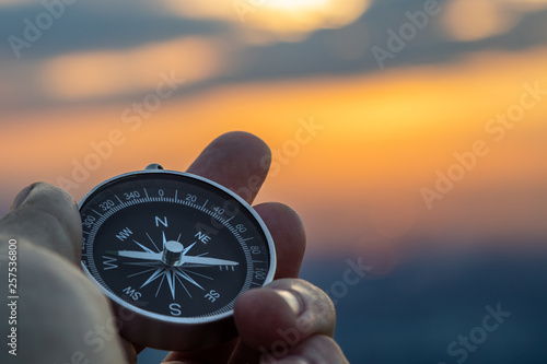 Cuadros en Lienzo compass in hand with sunset sky on the background