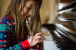 © Cavan Images - Young girl playing piano