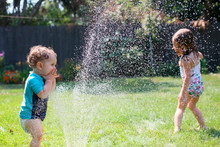 Playing In The Sprinkler. 