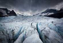 Rear View Of Man Ascending Glacier