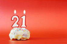 Twenty One Years Birthday. Cupcake With White Burning Candle In The Form Of Number 21. Vivid Red Background With Copy Space