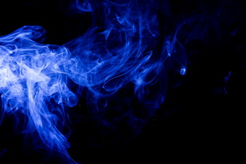 Blue smoke on black background