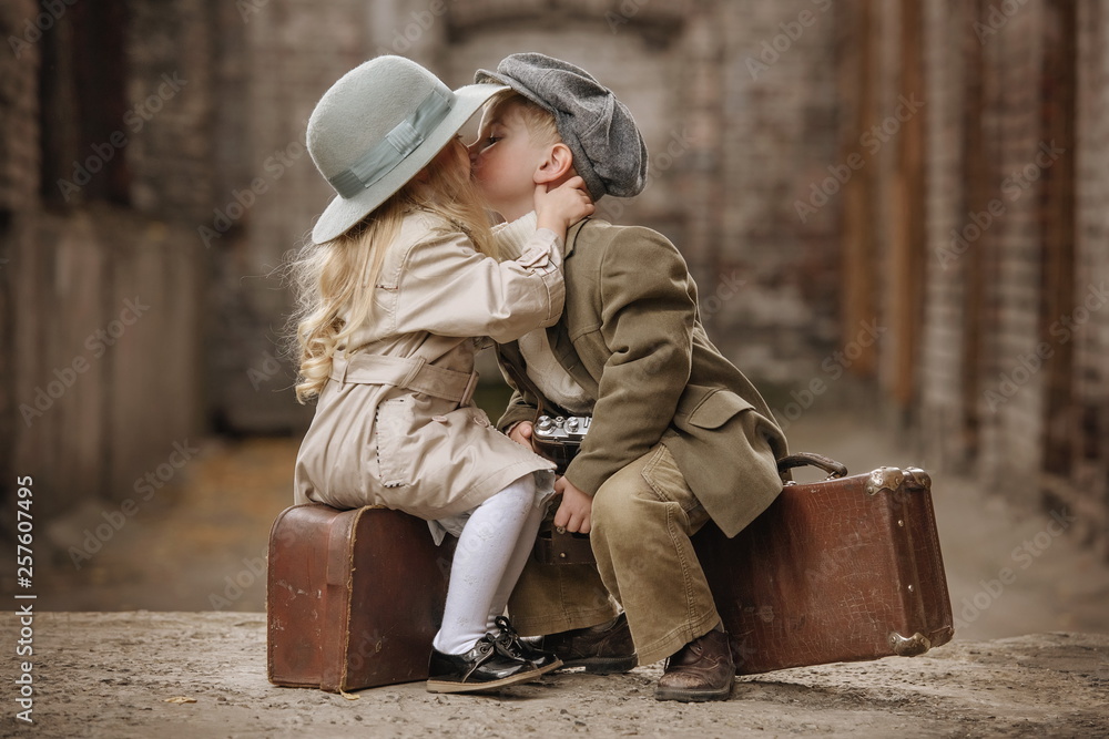 Romantic meeting of two children in the old town - obrazy, fototapety, plakaty 