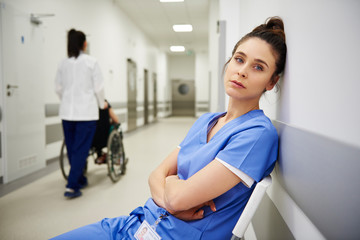 Wall Mural - Portrait of tired doctors after long day at work