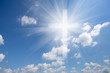 Christian shining cross in blue cloudy sky