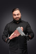 Bearded butcher with meat and knife