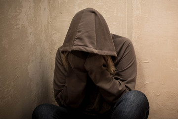 Portrait of man sad, drug addict man sitting on the floor in corner