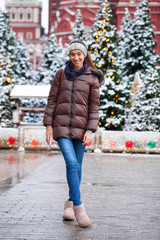 Poster - Portrait of a young brunette woman in down jacket