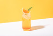 canvas print picture - Cold and refreshing orange punch cocktail with orange slice on yellow background. summer drink.