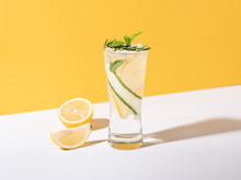 Mojito Cocktail With Lemon And Mint In Glass On Yellow Background. Summer Drink.
