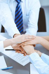 Business people group joining hands and representing concept of friendship and teamwork