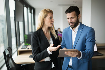 Wall Mural - businesspeople discussing while using digital tablet in office