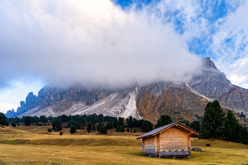 Wall Mural - Wooden rural farmer's shed (hut) in Seiser Alm meadow in the Dolomites, North Italy, Sudtirol (Trentino / Alto Adige). Scenic autumn view of a big valley in the Alps Mountains.
