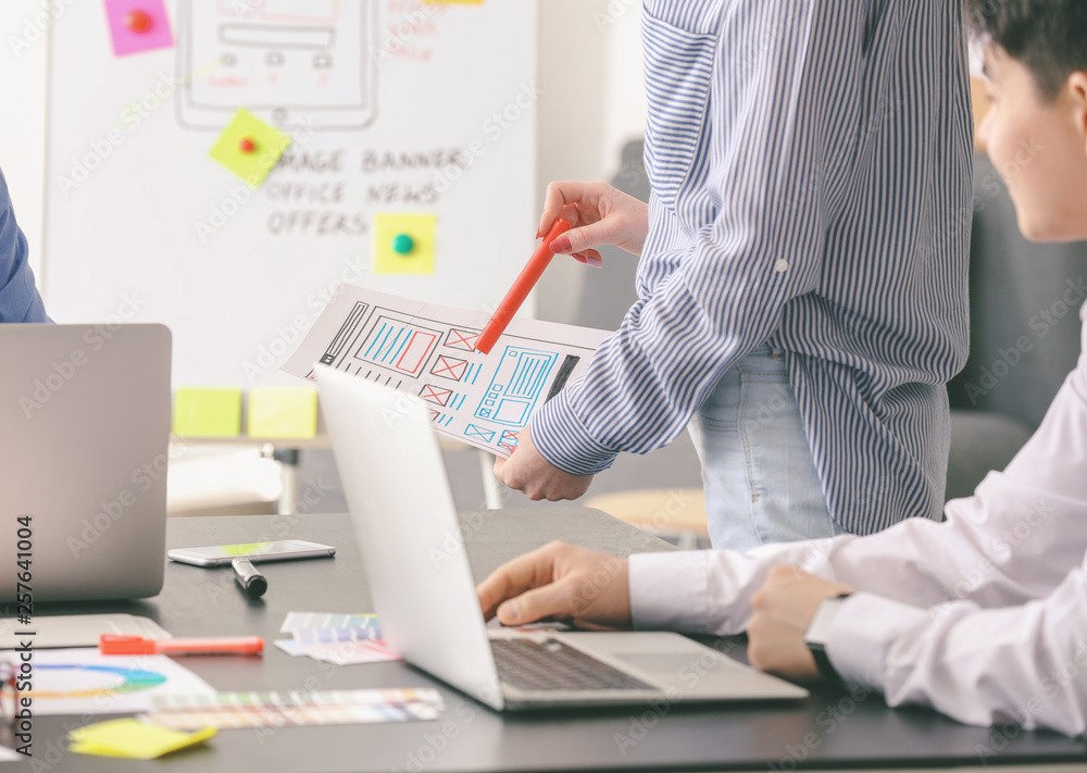 Young IT designers working in office