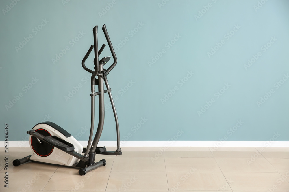 Modern machine near color wall in gym