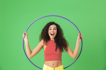 Sticker - Photo of energetic woman 20s wearing summer clothes doing exercises with hula hoop during gymnastics