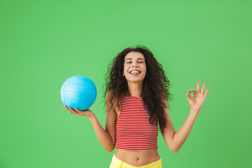 Sticker - Image of joyful woman 20s wearing summer clothes smiling and holding volley ball