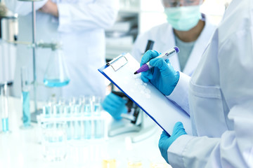 scientists analyzing study data and evaluating microscope. health care researchers doing some resear