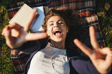 Poster - Top view of a lovely young teenage girl laying on a blanket