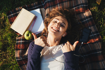 Sticker - Top view of a lovely young teenage girl laying on a blanket