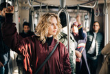 Fototapeta Las - Image of curly blonde riding in bus.
