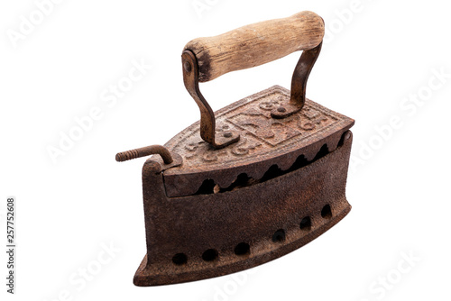 Cuadros en Lienzo Close up of an antique and rusty iron from coal ironing with wooden handle, isolated on white background