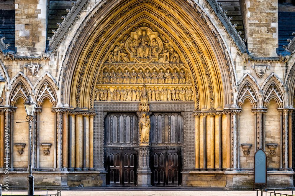 London, United Kingdom famous Westminster Abbey architecture closed large church doors facade exterior with nobody closeup entrance - obrazy, fototapety, plakaty 