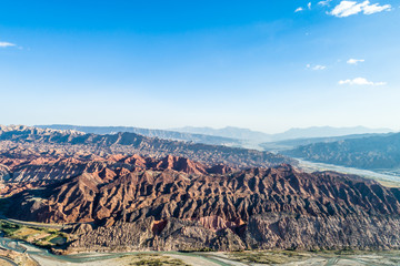 Wall Mural - Xinjiang Danxia National Geopark -   China. Chinese Danxia multicolor danxia landform rainbow hills unusual colored rocks sandstone erosion layers of Red Yellow and Orange stripes.