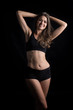 © Johnstocker - Beautiful woman with healthy body on black background
