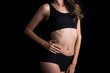 © Johnstocker - Beautiful woman with healthy body on black background