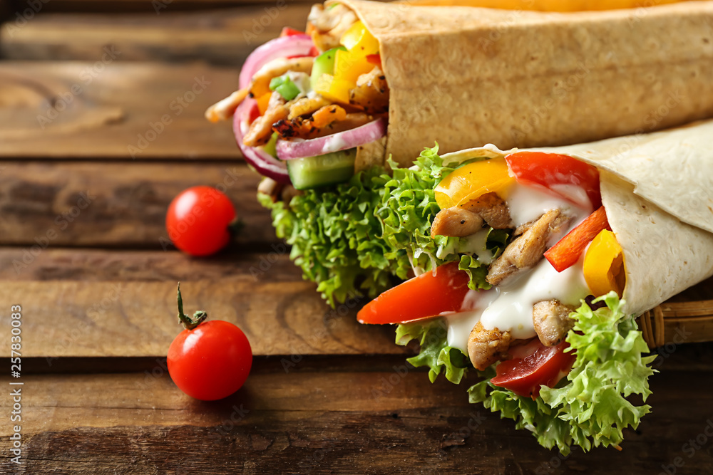 Tasty doner kebabs on wooden table