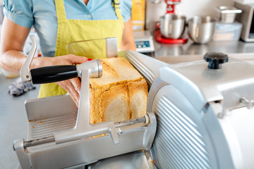 Woman's hand putting bread in machine