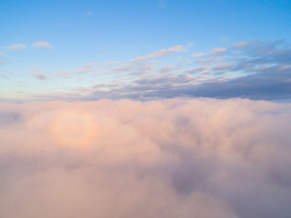  Aerial view White clouds in blue sky. Top view. View from drone. Aerial bird's eye view. Aerial top view cloudscape. Texture of clouds. View from above. Sunrise or sunset over clouds