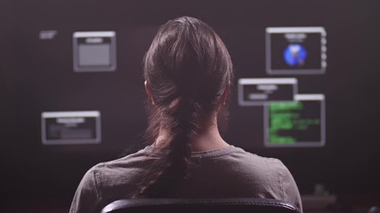 A man works at a computer. He is a programmer or hacker. On the monitor a lot of software keys. 4K Slow Mo